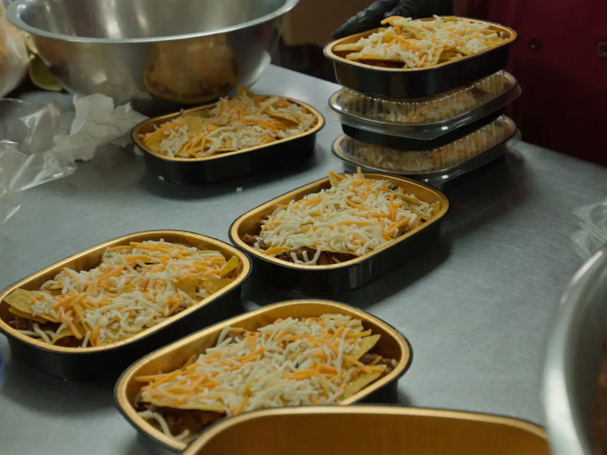 Trays of prepared portions being assembled for an order