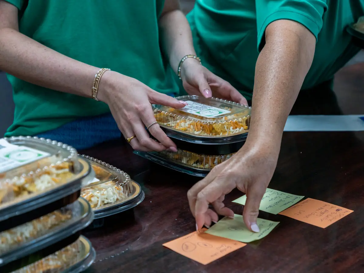 Labelling a prepared meals-to-go tray at the counter