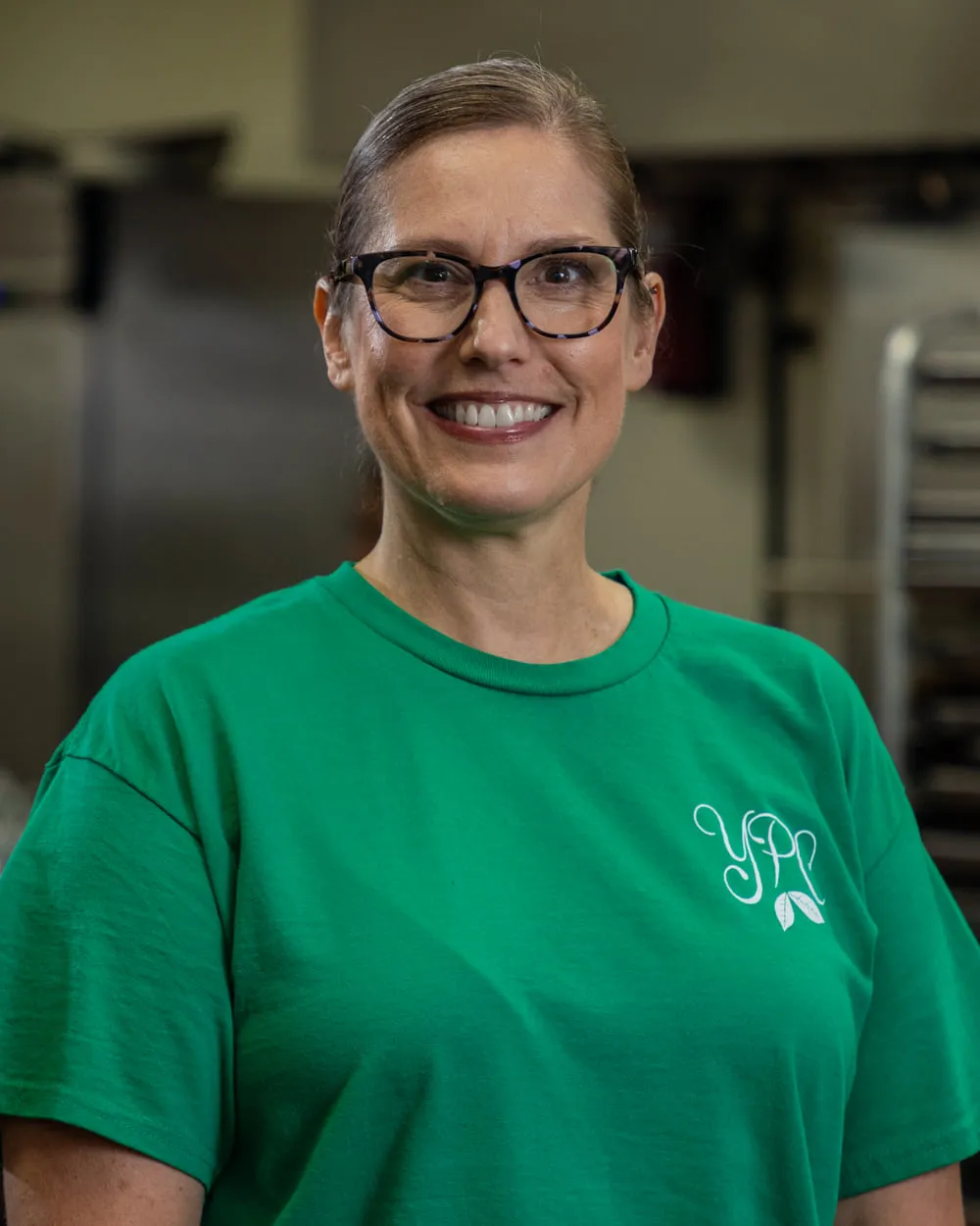 Janet Coble in a YPC Market shirt in the kitchen