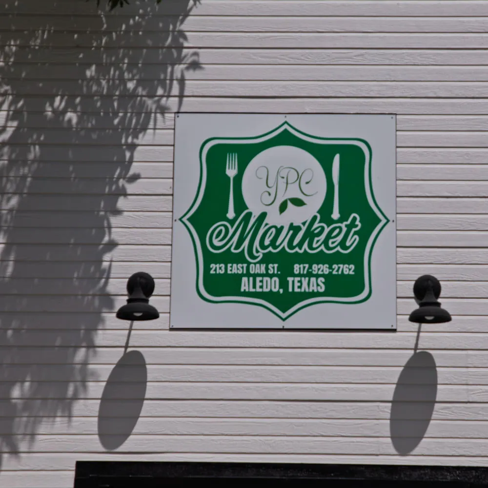 The YPC Market sign on the building at 213 East Oak Street