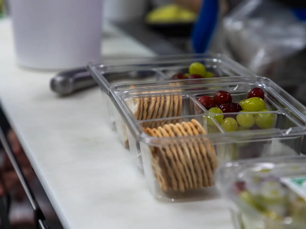 A grab-and-go tray of crackers, grapes and olives from the cold case